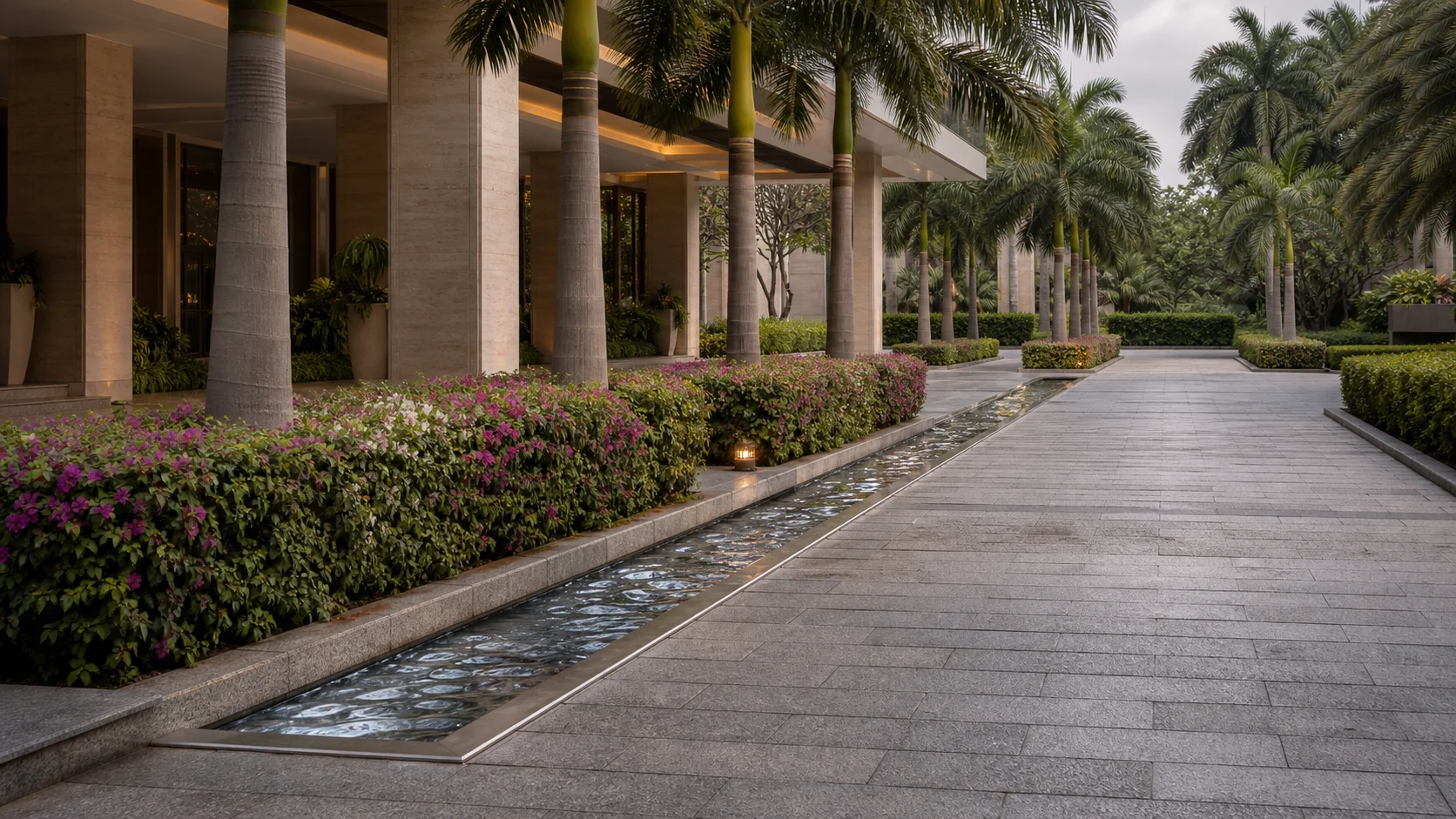 Commercial arrival garden with reflective water feature, structured planting, and premium entry experience.